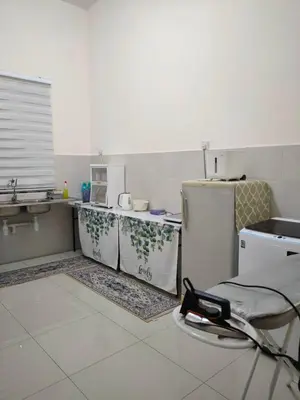 a kitchen with a sink and a refrigerator at Rana Homestay Ipoh Perak in Tanjung Rambutan