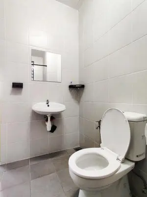 a white bathroom with a toilet and a sink at Hygge Living Kampar II (Near UTAR) in Kampar