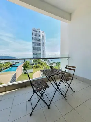 two chairs and a table on a balcony with a view at Southbay Seaview Condo A11 #Queensbay #SPICE in Bayan Lepas