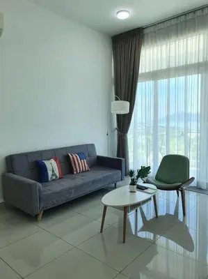 a living room with a blue couch and a table at Southbay Seaview Condo A11 #Queensbay #SPICE in Bayan Lepas