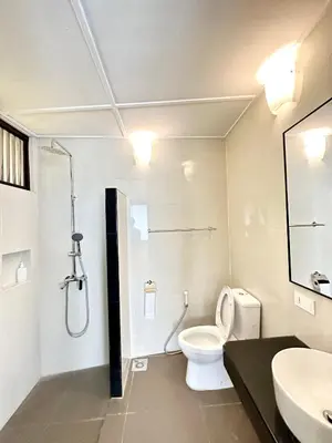 a bathroom with a shower and a toilet and a sink at Madras Inn 58-1 in George Town