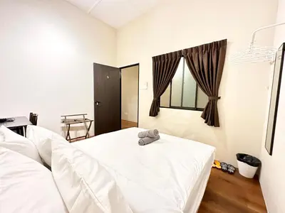 a bedroom with two white beds and a window at Madras Inn 58-1 in George Town
