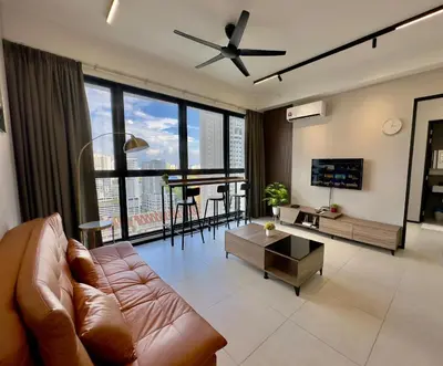 a living room with a couch and a ceiling fan at Cozy Urban Suites Georgetown View by 3C in Jelutong