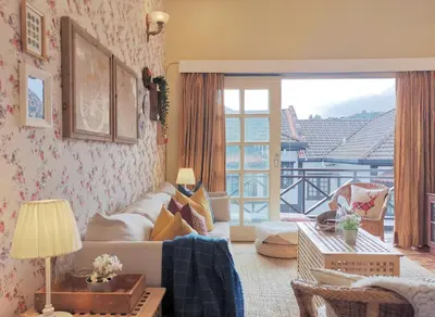 a living room with a couch and a window at Green Hill Tanah Rata Cameron Highland in Tanah Rata