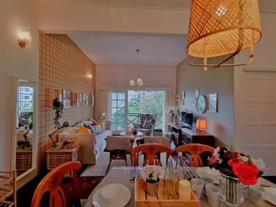a kitchen and living room with a table and chairs at Green Hill Tanah Rata Cameron Highland in Tanah Rata