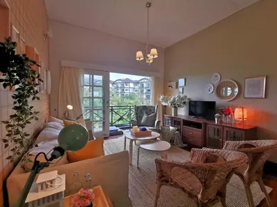 a living room with a couch and a table at Green Hill Tanah Rata Cameron Highland in Tanah Rata