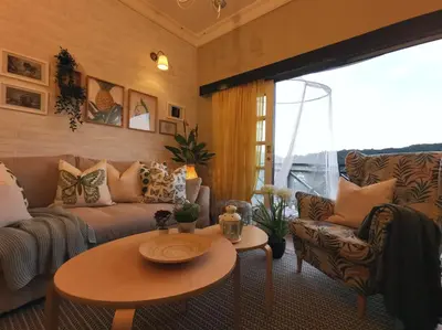 a living room with a couch and a table at Green Hill Tanah Rata Cameron Highland in Tanah Rata