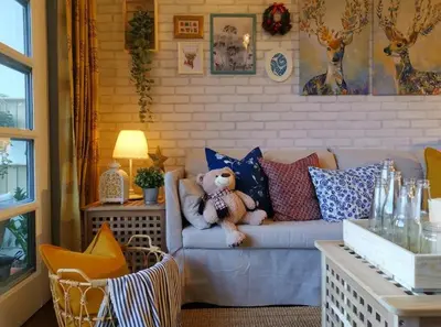 a teddy bear sitting on a couch in a living room at Green Hill Tanah Rata Cameron Highland in Tanah Rata