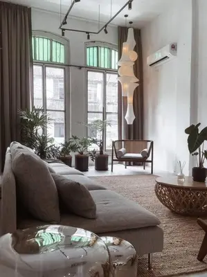 a living room with a couch and some windows at Heritage Boutique Home in George Town