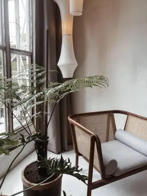 a living room with a chair and a plant at Heritage Boutique Home in George Town