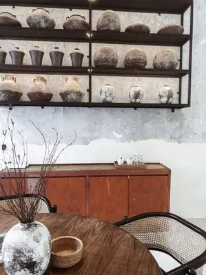 a table with chairs and a vase on top at Heritage Boutique Home in George Town