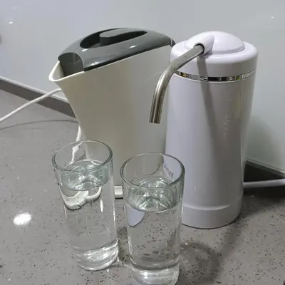 two glasses of water sitting next to a juicer at Veneto Penang homestay 3BR with infinity pool in Jelutong