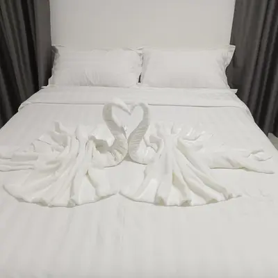 two swans making a heart shape on a bed at Veneto Penang homestay 3BR with infinity pool in Jelutong