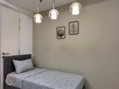 a bedroom with a bed and two pictures on the wall at Tropicana 218 Macalister WL in George Town