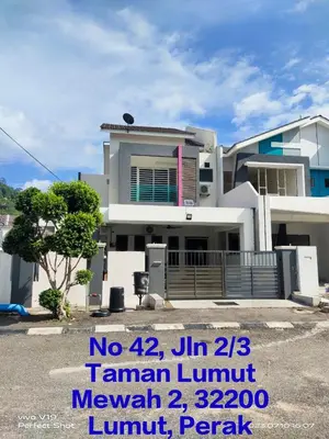 a large white house with a sign in front of it at Homestay Mewah Lumut in Lumut