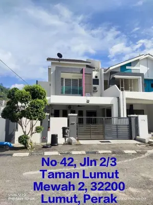 a large white house with a sign in front of it at Homestay Mewah Lumut in Lumut