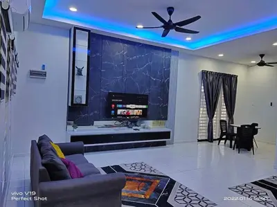 a living room with a couch and a ceiling fan at Homestay Mewah Lumut in Lumut