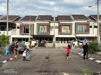 a group of people playing in a parking lot at Homestay Mewah Lumut in Lumut