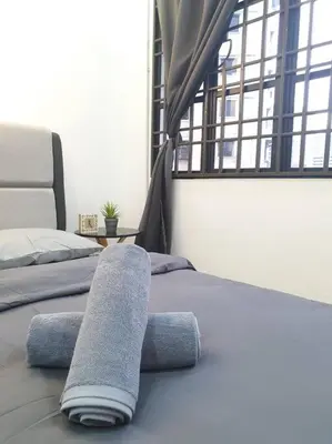 a bedroom with two beds with towels on them at 3 Storey Bangalow near Spice Arena & Queensbay Mall in Bayan Lepas