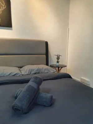 a stuffed animal laying on top of a bed at 3 Storey Bangalow near Spice Arena & Queensbay Mall in Bayan Lepas