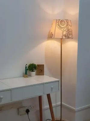 a lamp sitting next to a white table with a lamp at 3 Storey Bangalow near Spice Arena & Queensbay Mall in Bayan Lepas