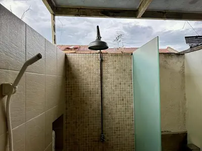 a bathroom with a shower with a bell on the wall at (New) Eternal Granpa’s heritage(UNESCO)/11pax/3BR in George Town
