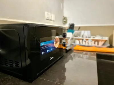 a black microwave on a counter in a kitchen at (New) Eternal Granpa’s heritage(UNESCO)/11pax/3BR in George Town