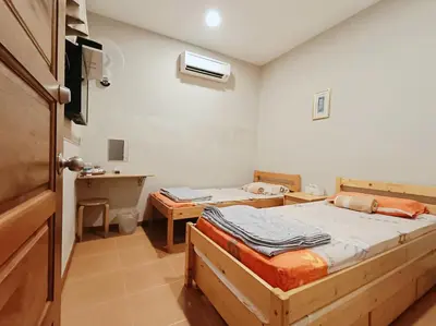 a room with two beds and a sink in it at Lung Tok Entreprise \u8336\u9986\u6c11\u5bbf in Bukit Mertajam
