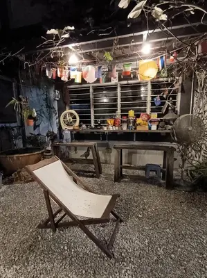 a chair in front of a table in a kitchen at Lung Tok Entreprise \u8336\u9986\u6c11\u5bbf in Bukit Mertajam