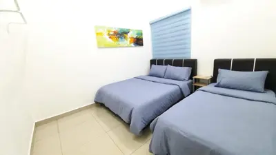 a bedroom with two beds and a painting on the wall at THE MAJESTIC IPOH B7 by ZamanJa in Ipoh