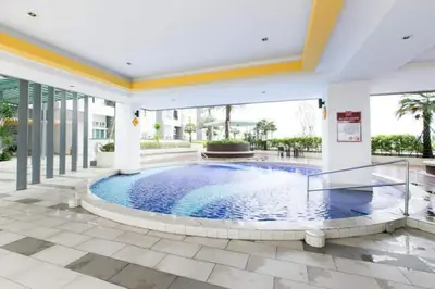 a swimming pool in the middle of a building at THE MAJESTIC IPOH B7 by ZamanJa in Ipoh