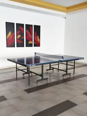 a ping pong table in a room with paintings at THE MAJESTIC IPOH B7 by ZamanJa in Ipoh