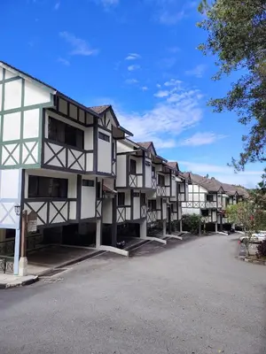 a row of apartment buildings in a parking lot at Sunrise View One Bedroom Apartment at Equatorial Hill Resort in Brinchang