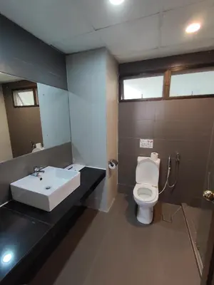 a bathroom with a white toilet and a sink at Sunrise View One Bedroom Apartment at Equatorial Hill Resort in Brinchang