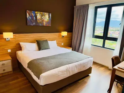 a bedroom with a bed and a large window at Hygge Living@Sunway Onsen in Tambun