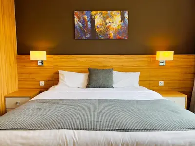 a bedroom with a large bed with two lamps at Hygge Living@Sunway Onsen in Tambun