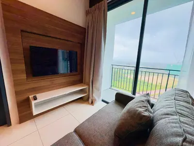 a living room with a couch and a large window at Hygge Living@Sunway Onsen in Tambun