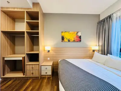 a hotel room with a bed and a tv at Hygge Living@Sunway Onsen in Tambun