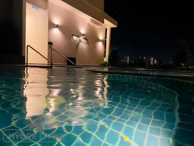 a swimming pool in front of a house at night at Hygge Living@Sunway Onsen in Tambun