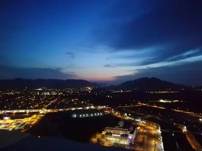 a view of a city at night with lights at 5D Homestay in Sitiawan