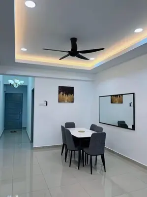 a dining room with a ceiling fan and a table and chairs at 5D Homestay in Sitiawan
