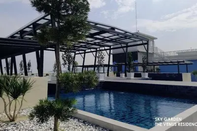 a swimming pool in a resort with a bridge in the background at 5D Homestay in Sitiawan