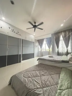 a bedroom with two beds and a ceiling fan at Art Homestay 4 Bedrooms House by Mr Homestay in Teluk Intan