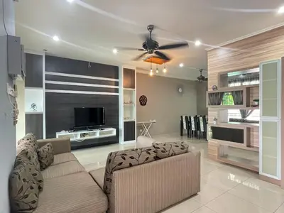 a living room with a couch and a flat screen tv at Art Homestay 4 Bedrooms House by Mr Homestay in Teluk Intan