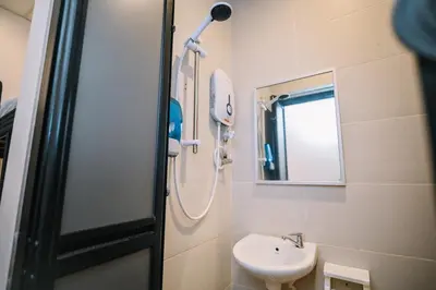 a bathroom with a sink and a shower at Swing & Pillows - 75 Chulia St, Georgetown Penang in George Town