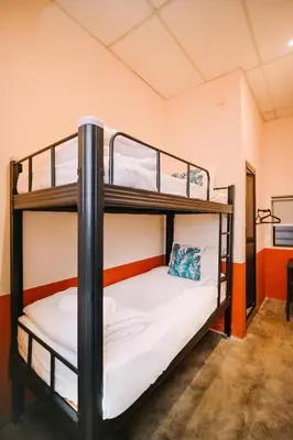 a bunk bed room with two bunk beds at Swing & Pillows - 75 Chulia St, Georgetown Penang in George Town