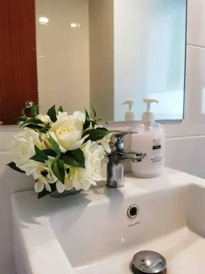a vase of flowers sitting on a bathroom sink at [NEW LAUNCH] SUNRISE GURNEY SEAVIEW'63 无敌日出海景63 in George Town