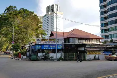 a man walking down a street in front of a building at [NEW LAUNCH] SUNRISE GURNEY SEAVIEW'63 无敌日出海景63 in George Town