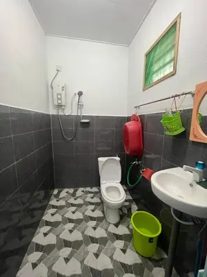a bathroom with a toilet and a sink at Nipah Medium Roomstay Parit Buntar in Parit Buntar