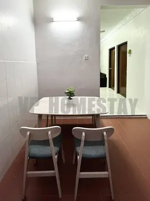 a table and two chairs in a room at VP Homestay - Malay Only in Ipoh